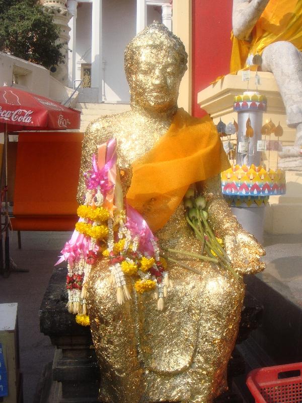 Buddha statue covered in flowers, Nakhon Pathom Thailand