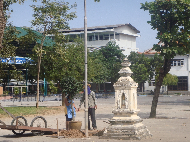 Locals cleaning the temple ground, Thailand